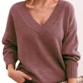 Close-up of mauve V-neck knitted sweater featuring ribbed neckline and soft fabric texture. - Rouge Red