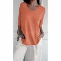 Detail of a casual women's orange V-neck knit sweater featuring stylish 3/4 sleeves - Coral