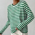 Detailed texture view of a classic green and white striped round neck knitted sweater. - Green