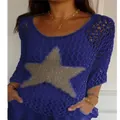 Close-up detail of women's blue knit top featuring a star pattern and hollow-out mesh design - Blue
