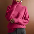 Detailed view of women's turtleneck knit sweater with pink diamond pattern texture. - Rose Red