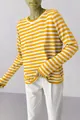 Detailed view of the yellow and white horizontal striped knit sweater with round neck. - Yellow