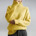 Close-up of vibrant yellow turtleneck sweater featuring a stylish diamond knit pattern - Yellow