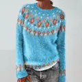 Close-up of blue knit sweater with orange geometric patterns and a cozy loose fit. - Lake Blue Diamond Pattern