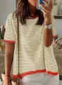 Close-up detail of a striped short sleeve knit top with vibrant orange contrast trim - S / Tops / Gold