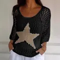 Women's black three-quarter sleeve knit top with large glittery star design - Black