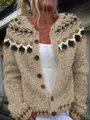 Detail of a loose women's knit cardigan featuring a black and white geometric diamond pattern. - S / Tops / Brown Jacquard (9250)
