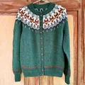 Close-up of green knitted cardigan featuring fox fair isle pattern and button details - S / Tops / Green (9085)