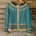 Detailed view of women's vintage Nordic knitted cardigan with teal and beige patterns - S / Tops / Vintage Blue