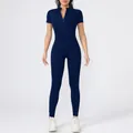 Detail of navy blue high-stretch short sleeve bodysuit with front zipper for yoga. - Navy Blue