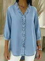 Close-up of ruffle trim details on a light blue faux denim V-neck casual blouse - XS / Tops / Light Blue