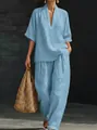 Elegant light blue V-neck short sleeve top and matching wide leg pants set on model - S / Top And Bottom / Sky Blue