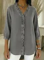 Detail view of a grey faux denim V-neck shirt with elegant front ruffle accents. - S / Tops / Gray