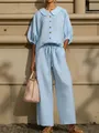 Detail of a light blue cotton linen set featuring a lantern sleeve shirt and wide-leg pants - XS / Top And Bottom / Sky Blue