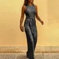 Close-up detail of a sparkling silver sequined sleeveless jumpsuit with a stylish waist tie - S / Top And Bottom / Black