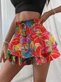 Detailed view of vibrant tropical floral print ruffled skort with high elastic waist and tie - S / Bottoms / Red