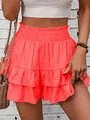 Vibrant coral ruffled skort for women with smocked high waist and layered hem design - S / Bottoms / Orange Red