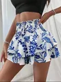 Detailed view of women's blue and white floral skorts with smocked high waist - S / Blue