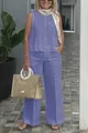 Full-length detail of a blue linen-style sleeveless top and wide-leg trousers on model. - Purple