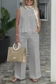 Full-body view of a woman wearing a light grey sleeveless cotton linen set with wide-leg pants. - S / Top And Bottom / Gray