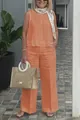 Outdoor full body shot of a chic orange sleeveless cotton linen set featuring wide-leg pants - Orange