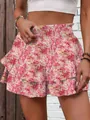 Close-up detail of women's pink floral print tiered wide-leg shorts with elastic high waist - S / Bottoms / Pink Print