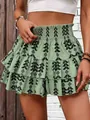 Close-up of sage green ruffled skort with black tribal geometric pattern and smocked waist. - S / Bottoms / Army Green Tribal Print