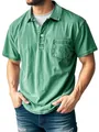 Close-up detail of a green acid-washed men's polo shirt with button collar and chest pocket - Green