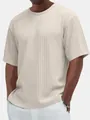 Detailed close-up of men's beige textured cable-knit round neck short sleeve t-shirt fabric. - Apricot