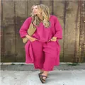Lifestyle shot of a vibrant pink cotton linen two-piece set for women with long sleeves - S / Top And Bottom / Rose Red