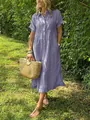 Outdoor lifestyle shot of a woman wearing a blue striped linen shirt dress with straw bag - S / Bottoms / Purple