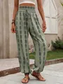 Close-up view of bohemian geometric print lantern pants in olive green with an elastic waist - S / Bottoms / Army Green