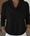 Detail of a black V-neck waffle knit sweater showing the neckline and fabric texture. - Black
