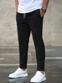 Full-length view of men's black drawstring jogger pants with tapered nine-point cut - S / Bottoms / Black