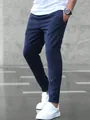 Close-up of navy blue mens business casual ankle-length trousers with white sneakers - Navy Blue