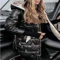 Detail view of women's black glossy hooded puffer jacket featuring triple zippers - S / Tops / Black