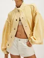 Close-up detail of oversized yellow knit cardigan featuring chunky texture and snap buttons - Yellow