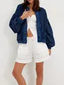 View of the relaxed fit and chunky knit texture of a blue vintage cardigan on a model - S / Tops / Dark Blue