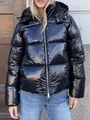 Detailed view of the glossy fabric and stitching on a black hooded puffer jacket for women. - Black