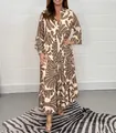 Elegant bohemian brown swirl print maxi dress featuring long sleeves and a tiered skirt design - S / Dresses / Coffee