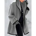 Side view detail of an oversized gray wool coat featuring elegant black contrast piping - S / Tops / Gray