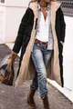A stylish woman wearing a long black puffer coat with warm beige sherpa lining outdoors - S / Tops / Black