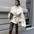 Elegant French style white wool coat featuring V-neck and chic waist belt detail view - Off White