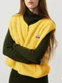 Detail of yellow sherpa fleece vest with button closure over green turtleneck - S / Tops / Yellow