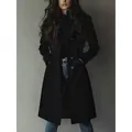 Detailed view of a black suede coat featuring a waist-cinching design and button closure - S / Tops / Black