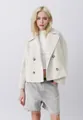 Detailed fashion shot of a stylish cream-colored cropped wool jacket with large lapels - White