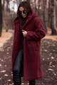 Woman wearing a burgundy long hooded teddy coat in a scenic autumn forest park setting. - S / Tops / Burgundy