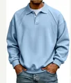 Detail view of men's light blue long sleeve polo sweatshirt with ribbed knit texture and buttons - Blue