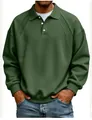 Close-up of olive green men's sweatshirt featuring ribbed shoulder detail and button lapel - Green