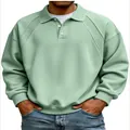 Close-up of men's sage green polo sweatshirt showing ribbed shoulder detail and buttons - M / Tops / Grass Green